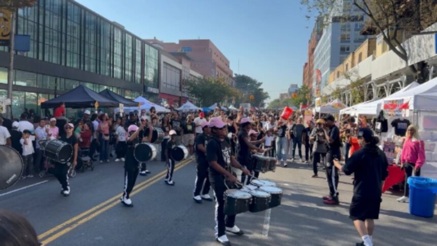 Visitors walking through the Fabulous 9th Avenue Street Fair in Hell's Kitchen, Manhattan, during one of New York City's largest annual street festivals.