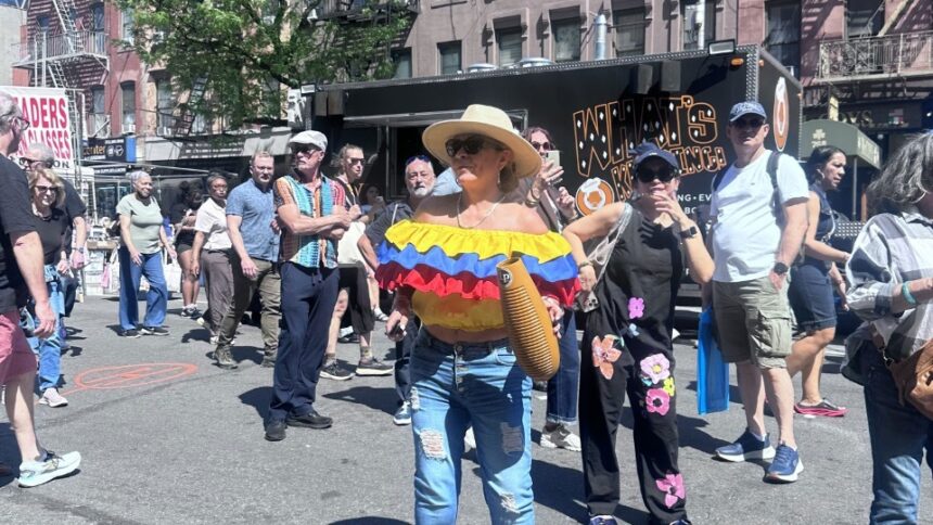 Visitors walking through the Fabulous 9th Avenue Street Fair in Hell's Kitchen, Manhattan, during one of New York City's largest annual street festivals.
