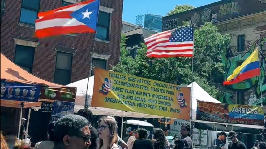Visitors walking through the Fabulous 9th Avenue Street Fair in Hell's Kitchen, Manhattan, during one of New York City's largest annual street festivals.