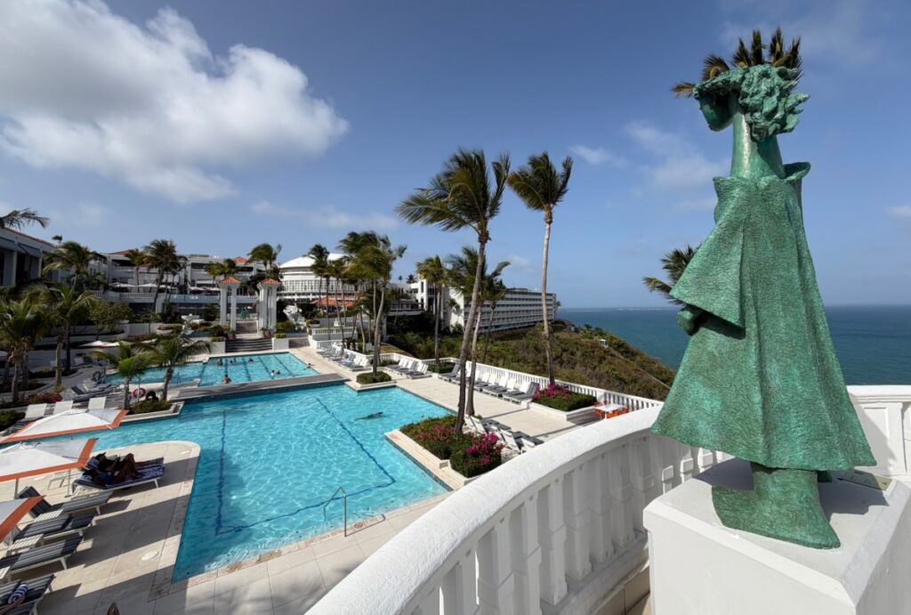 Green sculpture overlooking resort pool