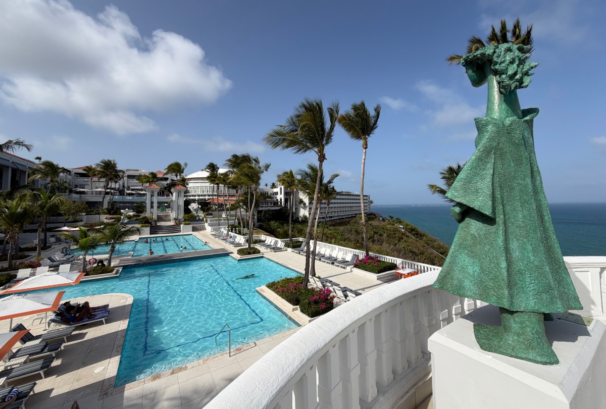 Green sculpture overlooking resort pool